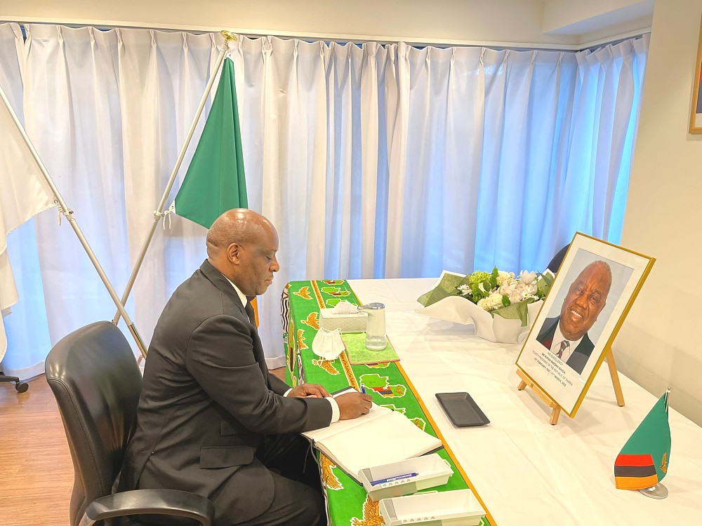 H.E. Ambassador Baraka Luvanda signing condolence book at the Embassy of Zambia in Tokyo