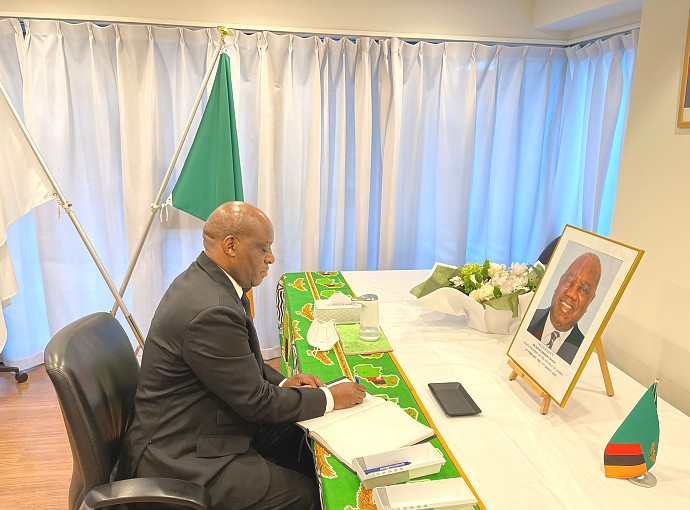 H.E. Ambassador Baraka Luvanda signing condolence book at the Embassy of Zambia in Tokyo